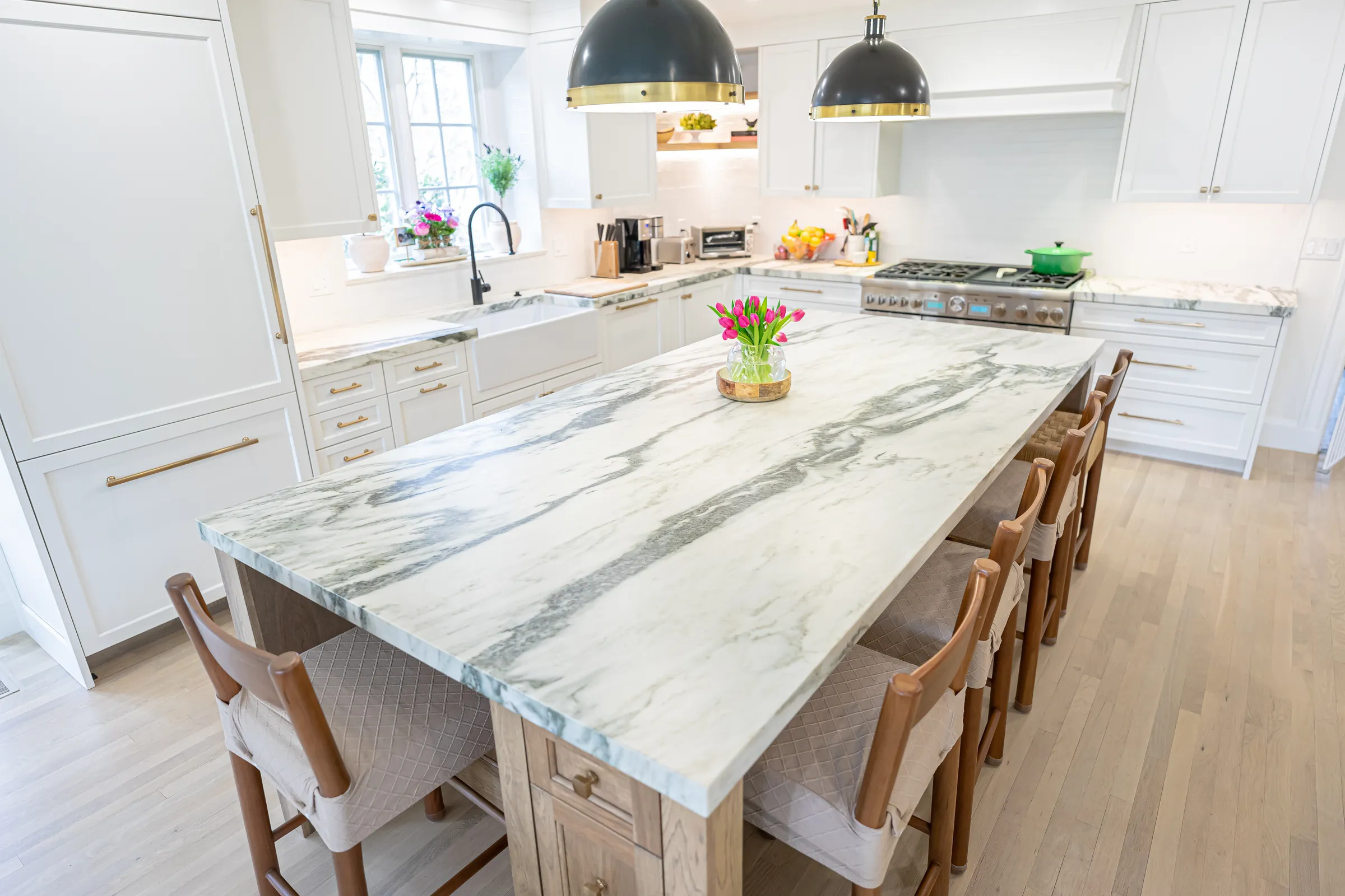Long quartzite island with waterfall edge and counter stools